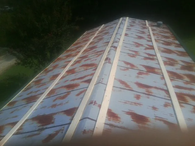Rusted metal roof panels with new wood purlins before replacement — Storm Damage Roof Repair in Blackshear by Roofing Brothers